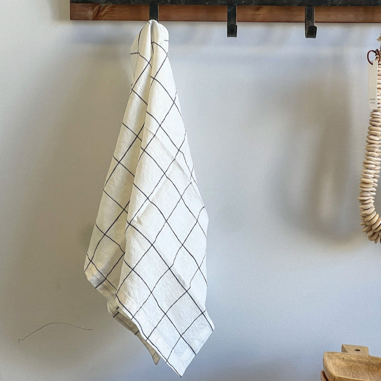 White linen tea towel with windowpane plaid design.