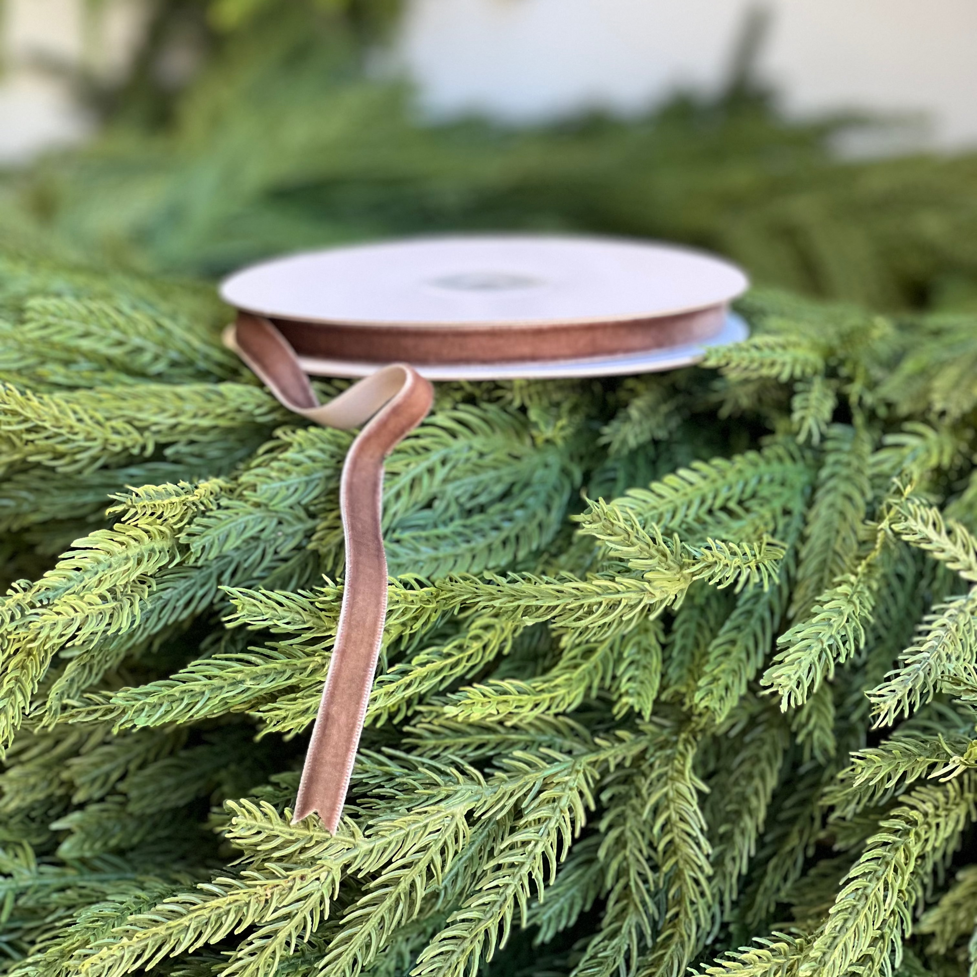 Spool of ribbon on a Christmas tree with green branches
