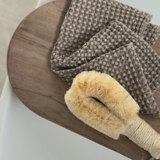Timber bath caddy with bathtime essentials.
